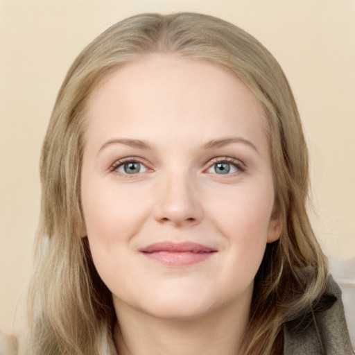 Joyful white young-adult female with long  brown hair and blue eyes