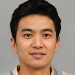 Joyful asian young-adult male with short  brown hair and brown eyes