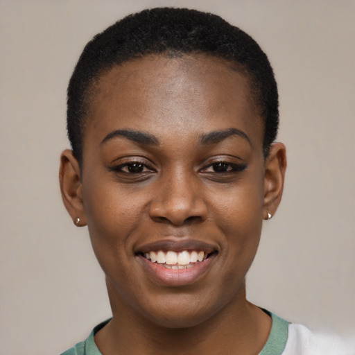 Joyful black young-adult female with short  black hair and brown eyes