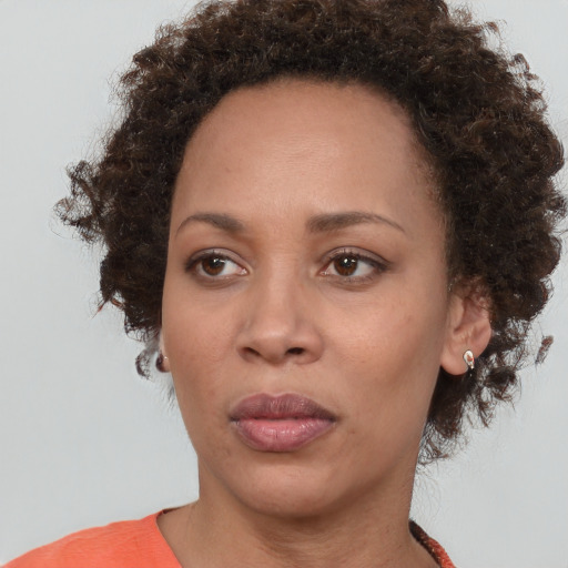 Neutral black adult female with medium  brown hair and brown eyes