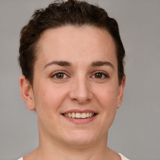 Joyful white young-adult female with short  brown hair and grey eyes