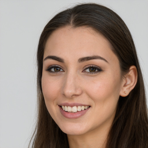 Joyful white young-adult female with long  brown hair and brown eyes