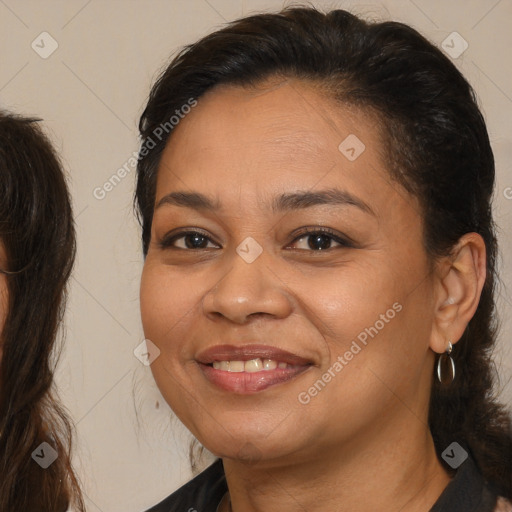 Joyful latino adult female with medium  brown hair and brown eyes