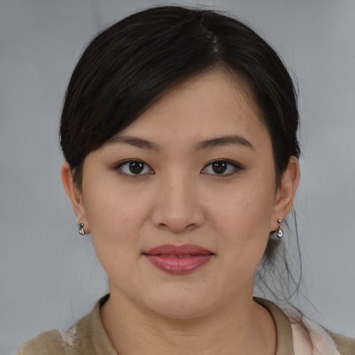Joyful asian young-adult female with medium  brown hair and brown eyes
