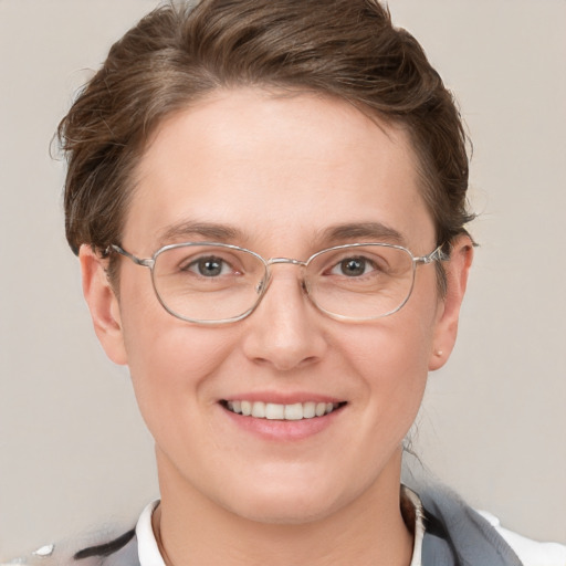 Joyful white adult female with short  brown hair and grey eyes