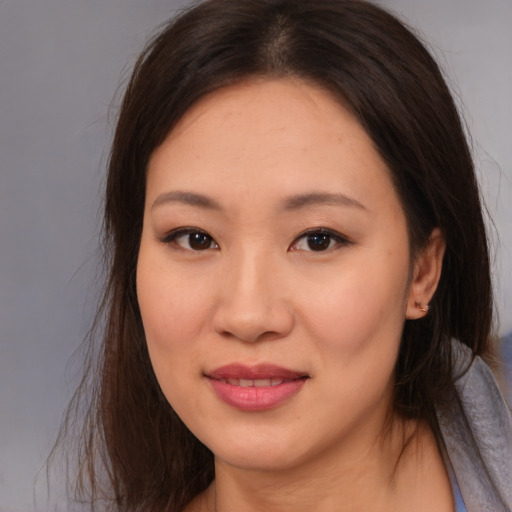 Joyful asian young-adult female with medium  brown hair and brown eyes