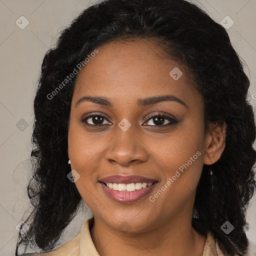 Joyful black young-adult female with long  brown hair and brown eyes