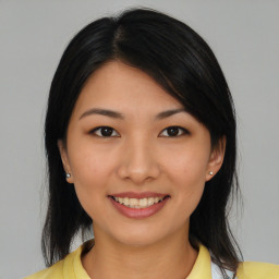 Joyful asian young-adult female with medium  black hair and brown eyes