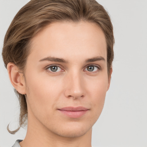 Joyful white young-adult female with short  brown hair and grey eyes