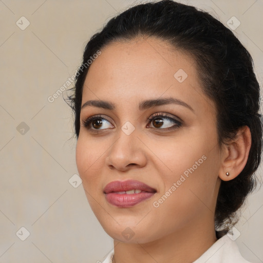 Joyful latino young-adult female with medium  brown hair and brown eyes