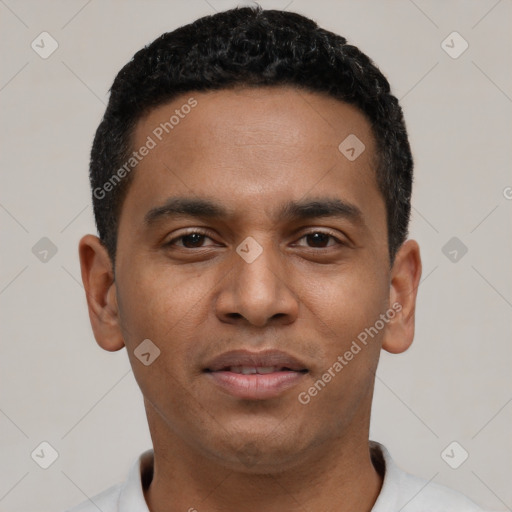 Joyful black young-adult male with short  black hair and brown eyes