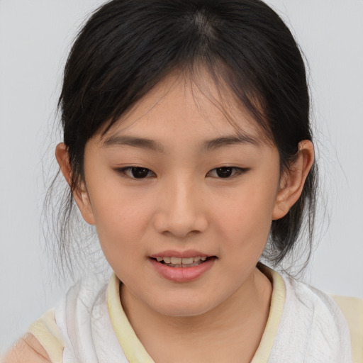 Joyful asian child female with medium  brown hair and brown eyes