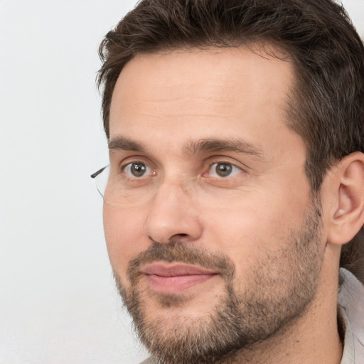 Joyful white adult male with short  brown hair and brown eyes