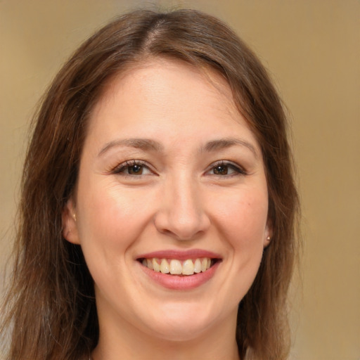 Joyful white young-adult female with long  brown hair and brown eyes