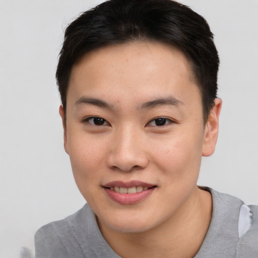 Joyful asian young-adult female with short  brown hair and brown eyes