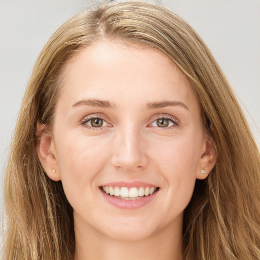 Joyful white young-adult female with long  brown hair and grey eyes