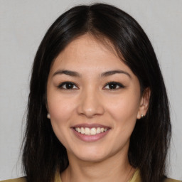 Joyful asian young-adult female with long  brown hair and brown eyes