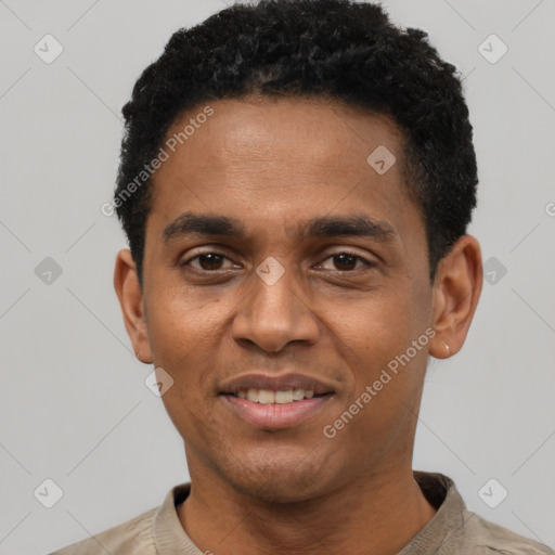 Joyful black young-adult male with short  black hair and brown eyes