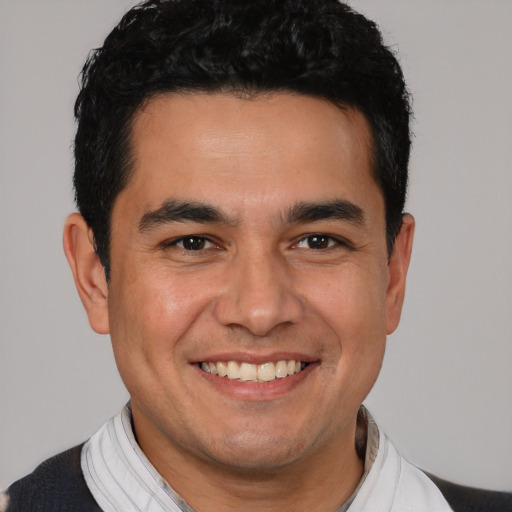 Joyful white young-adult male with short  black hair and brown eyes