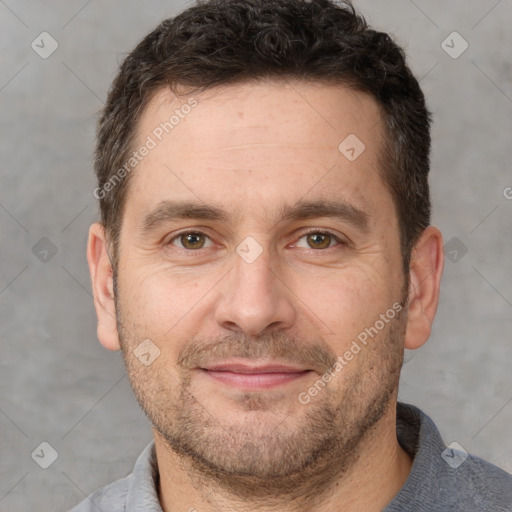 Joyful white adult male with short  brown hair and brown eyes