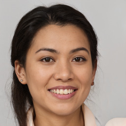 Joyful latino young-adult female with medium  brown hair and brown eyes