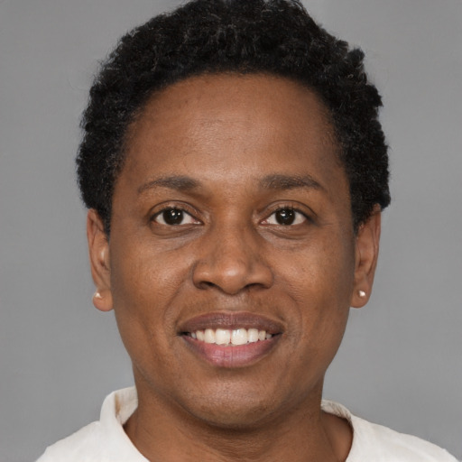 Joyful black young-adult male with short  black hair and brown eyes