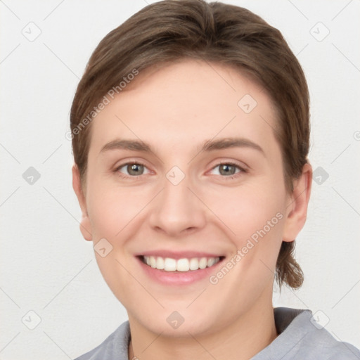 Joyful white young-adult female with short  brown hair and grey eyes