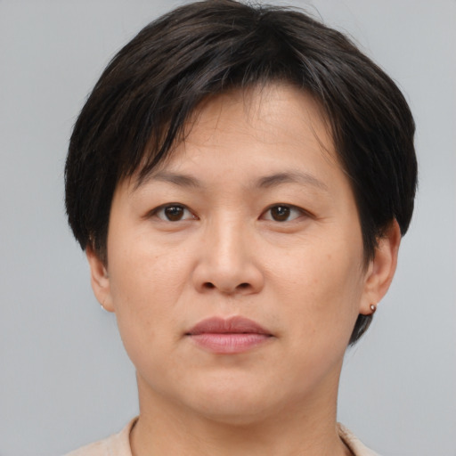 Joyful asian young-adult female with short  brown hair and brown eyes
