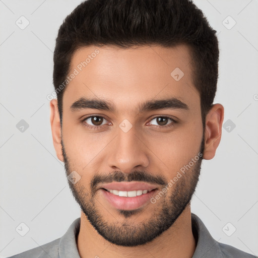 Joyful white young-adult male with short  brown hair and brown eyes