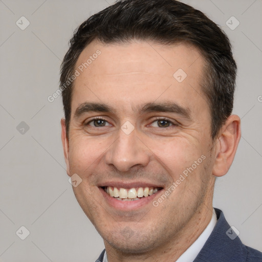 Joyful white adult male with short  brown hair and brown eyes