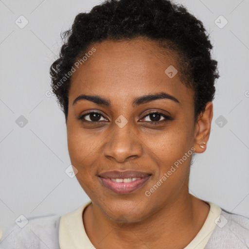 Joyful black young-adult female with short  black hair and brown eyes