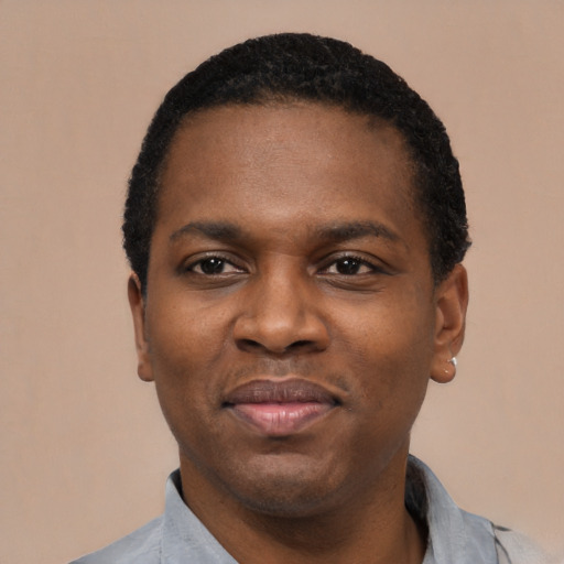 Joyful black young-adult male with short  black hair and brown eyes