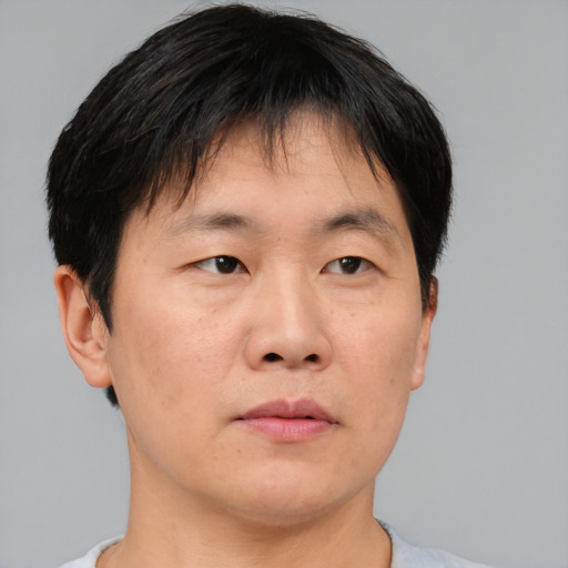 Neutral asian adult male with short  brown hair and brown eyes