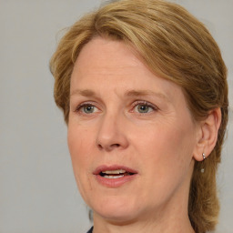 Joyful white adult female with medium  brown hair and blue eyes