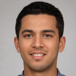 Joyful white young-adult male with short  black hair and brown eyes