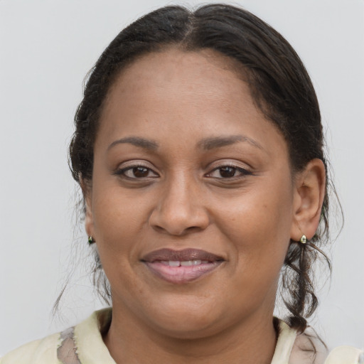 Joyful latino adult female with medium  brown hair and brown eyes