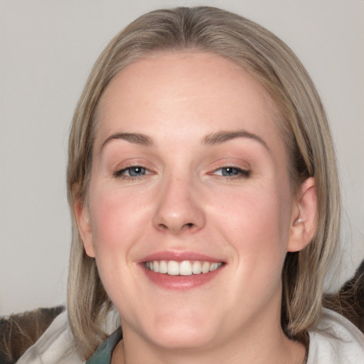 Joyful white young-adult female with medium  brown hair and blue eyes