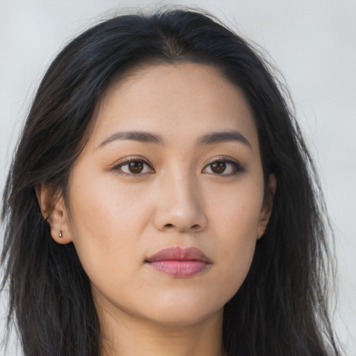 Joyful asian young-adult female with long  brown hair and brown eyes