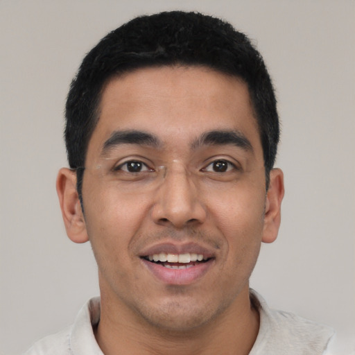 Joyful latino young-adult male with short  black hair and brown eyes