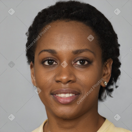 Joyful black young-adult female with short  black hair and brown eyes