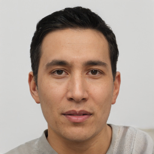 Joyful asian adult male with short  black hair and brown eyes