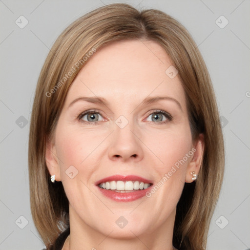 Joyful white adult female with medium  brown hair and blue eyes