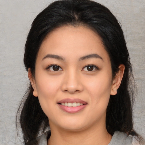 Joyful white young-adult female with medium  black hair and brown eyes