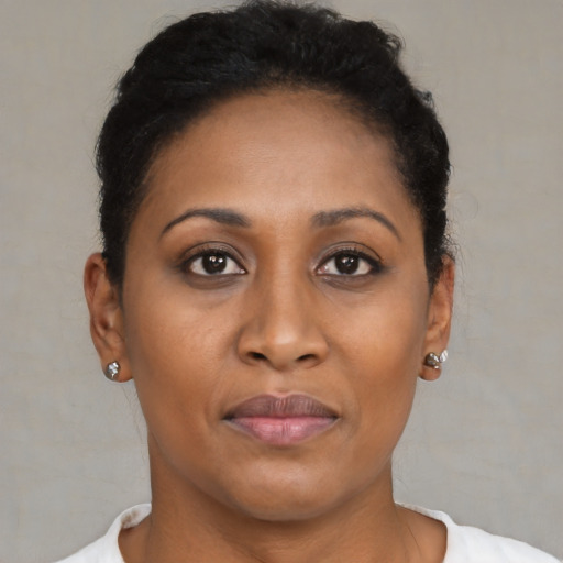 Joyful black young-adult female with short  brown hair and brown eyes