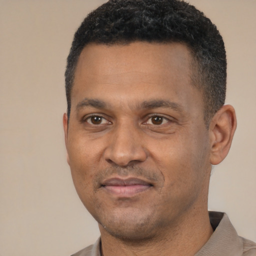Joyful latino adult male with short  black hair and brown eyes