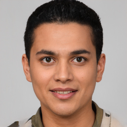 Joyful latino young-adult male with short  black hair and brown eyes