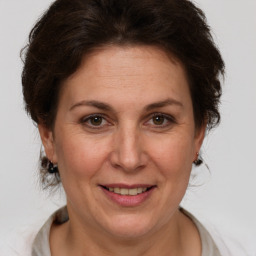 Joyful white adult female with short  brown hair and brown eyes