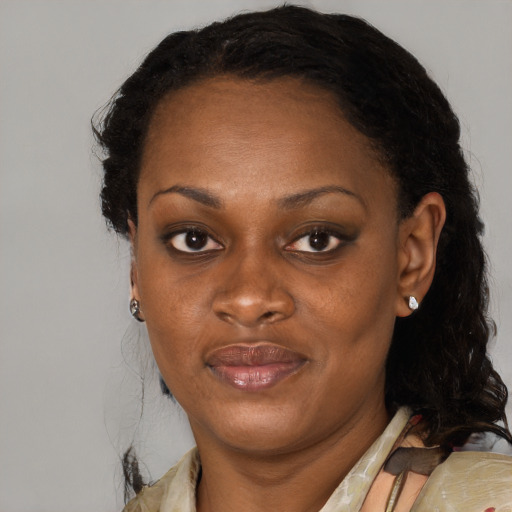 Joyful black adult female with medium  black hair and brown eyes