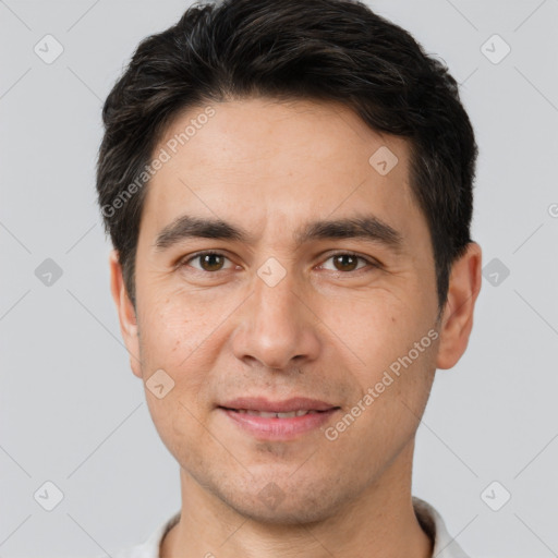 Joyful white young-adult male with short  black hair and brown eyes