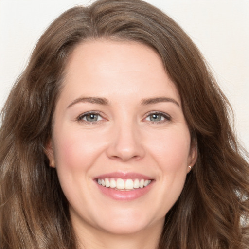 Joyful white young-adult female with long  brown hair and green eyes